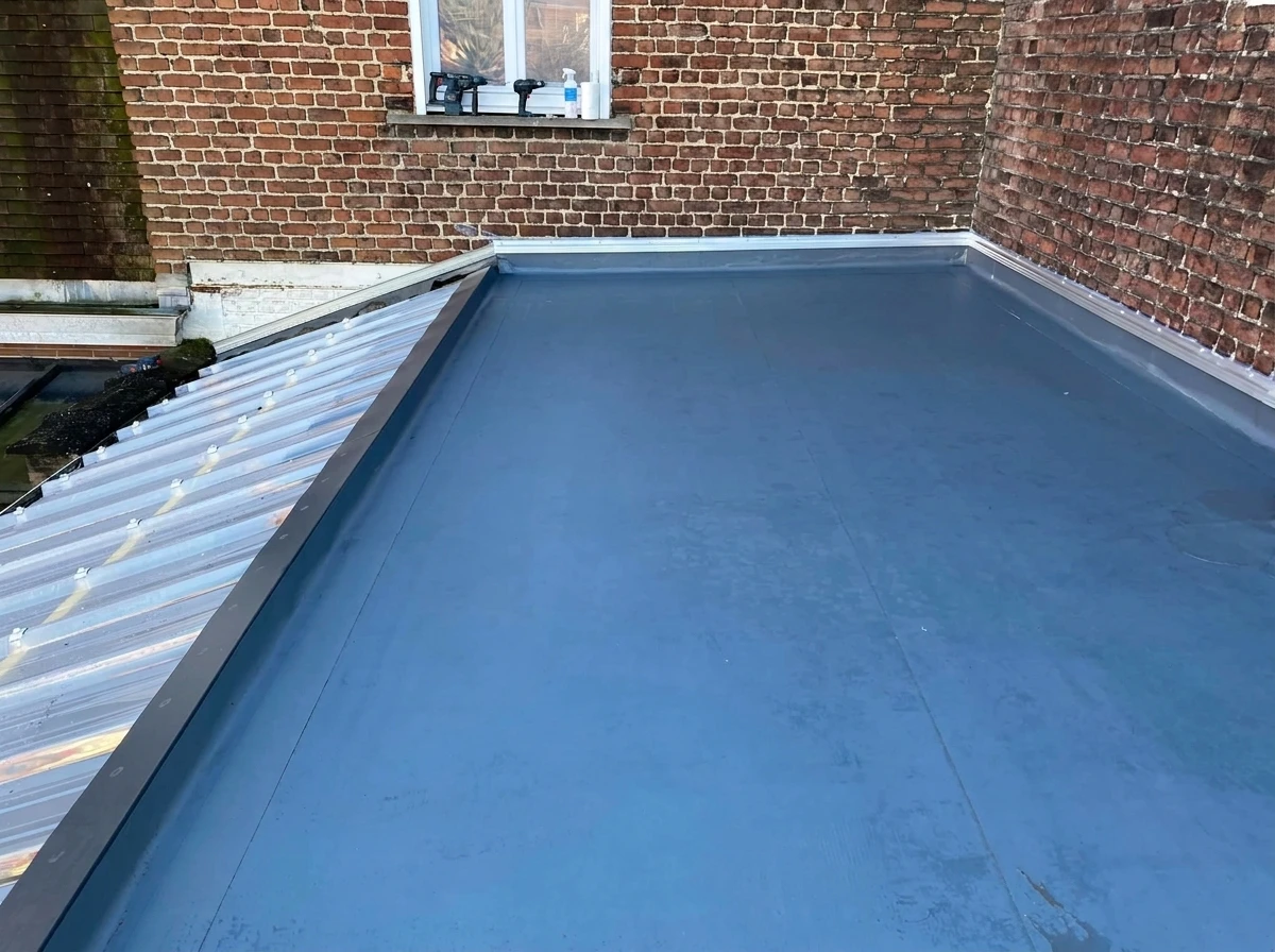 Vue aérienne d'une toiture résidentielle moderne avec bardeaux d'asphalte gris-bleu, structure complexe à multiples pans et lucarnes